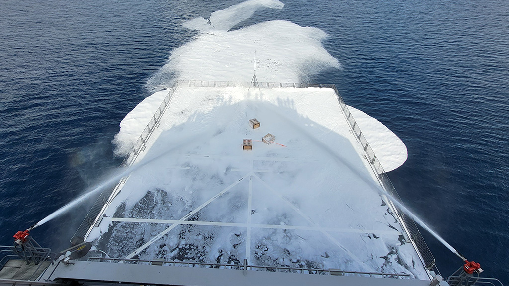 De schuimblusinstallaties op het helidek in actie tijdens de Sea Acceptance Test.